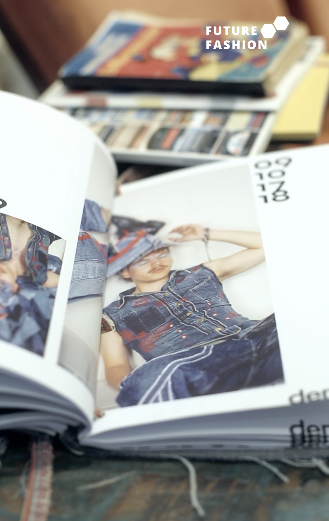 Open fashion magazine showing a photo of a woman wearing a denim vest and jeans, with the date October 18, 2018, and the words 'Future Fashion' in the top right corner.