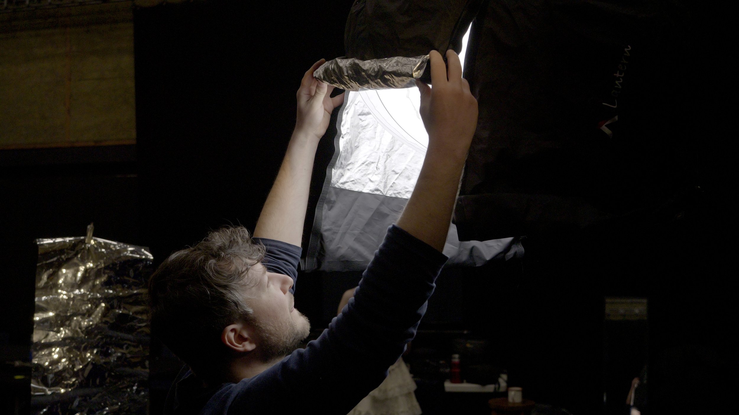 Adjusting studio lights for filming