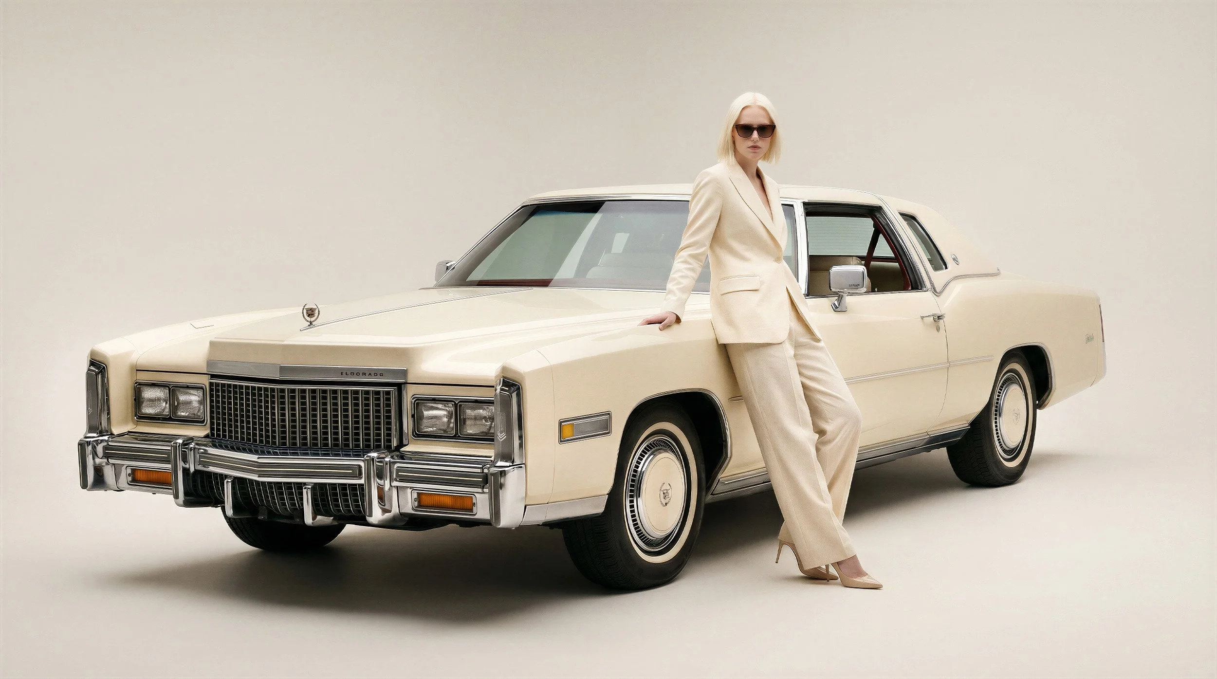 "Minimalist studio shot of a model leaning on a vintage white Cadillac against a neutral background. Demonstrating versatile product and model placement for e-commerce and catalogs."