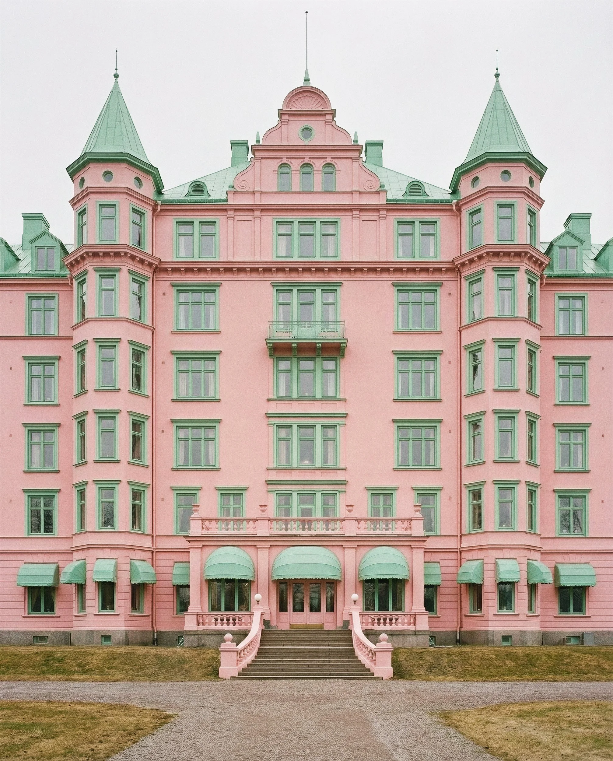 "Perfectly symmetrical architectural shot of a grand hotel in pastel pink and mint green tones. A synthetic environment created for high-end fashion storytelling by The Raw Lab visual engine."