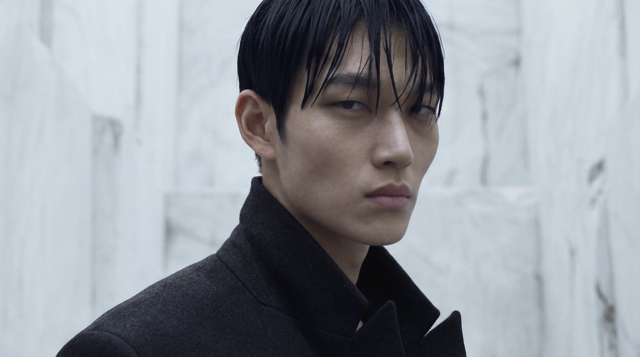 "Hyper-realistic portrait of a male digital twin model against a white marble quarry background. Part of the Monolith campaign, showcasing advanced AI-driven skin textures and cinematic lighting."