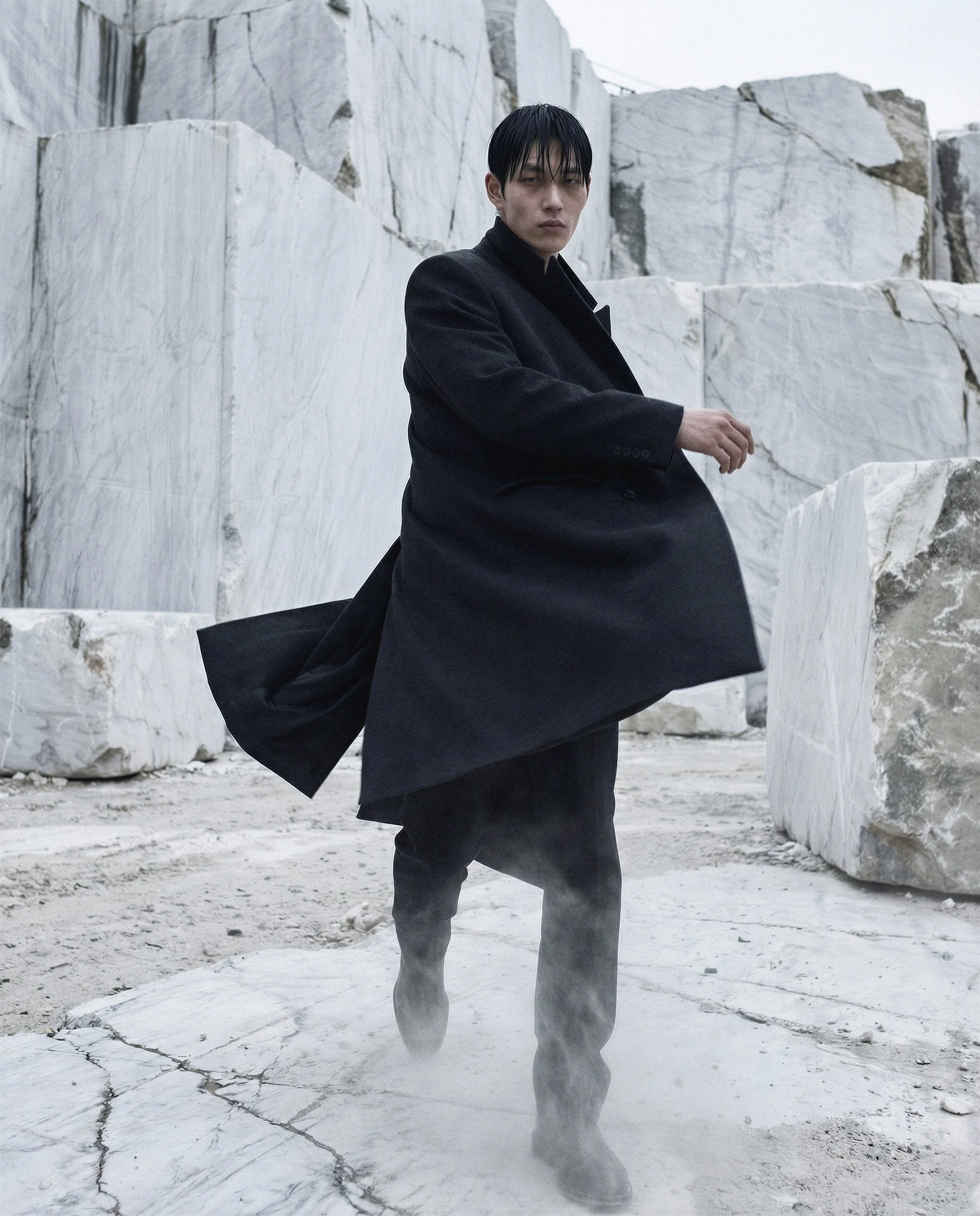 "Dynamic fashion shot of a model walking through a marble quarry with dust rising at his feet. This visual demonstrates the capability of AI to render complex physics and movement in high-fashion campaigns."