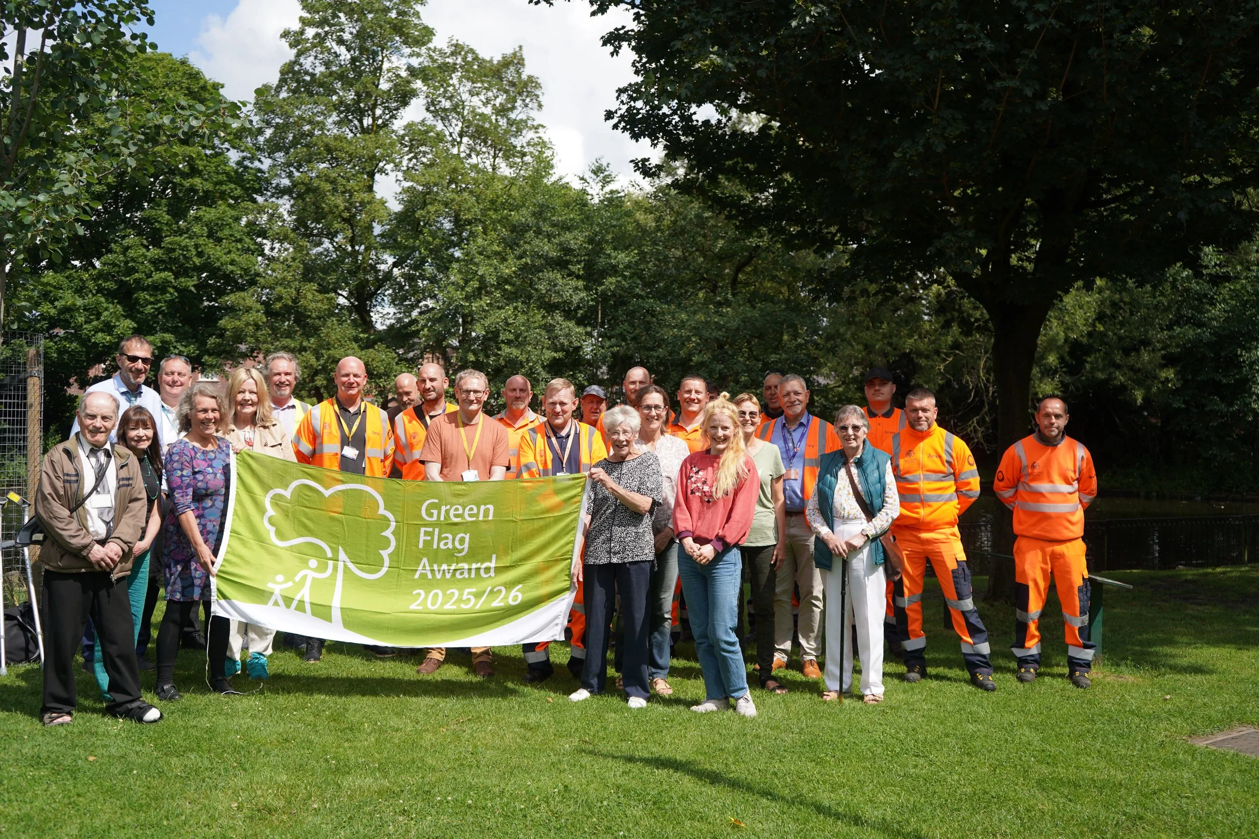group photo that includes workers from One Trafford celebrating the Green Flag Award 25/26