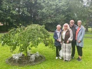 rory's parents with jackie and myra of fosp, standing next to rory's tree in stamford park