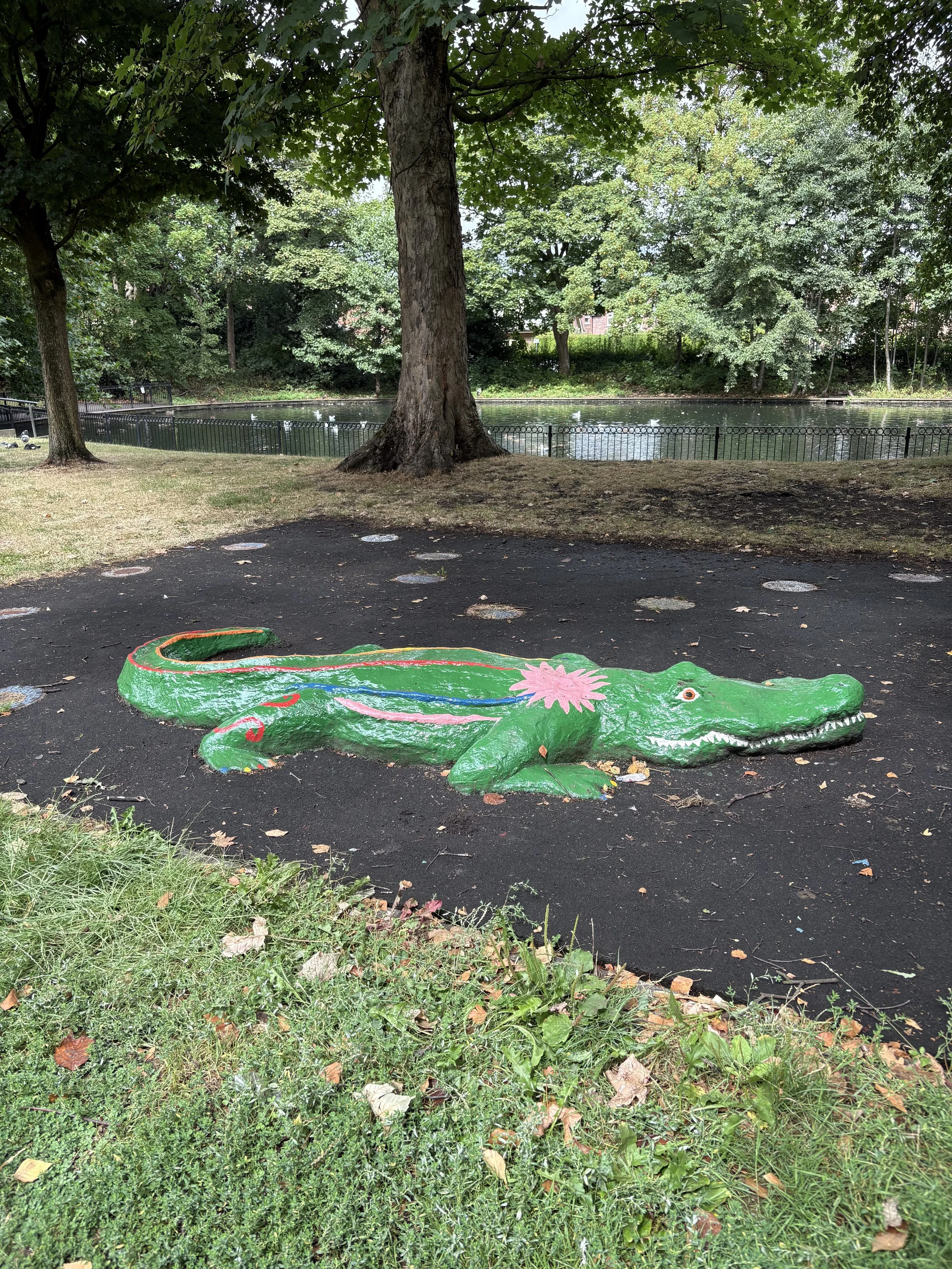 the large freshly painted crocodile in stamford park, that children play on