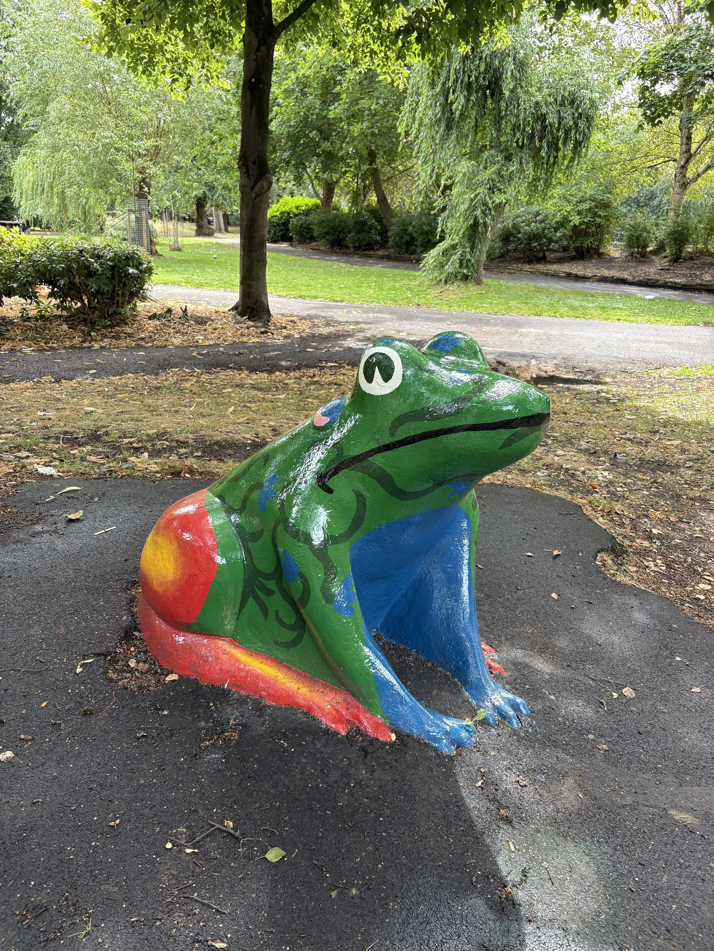 the large freshly painted frog in stamford park, that children play on