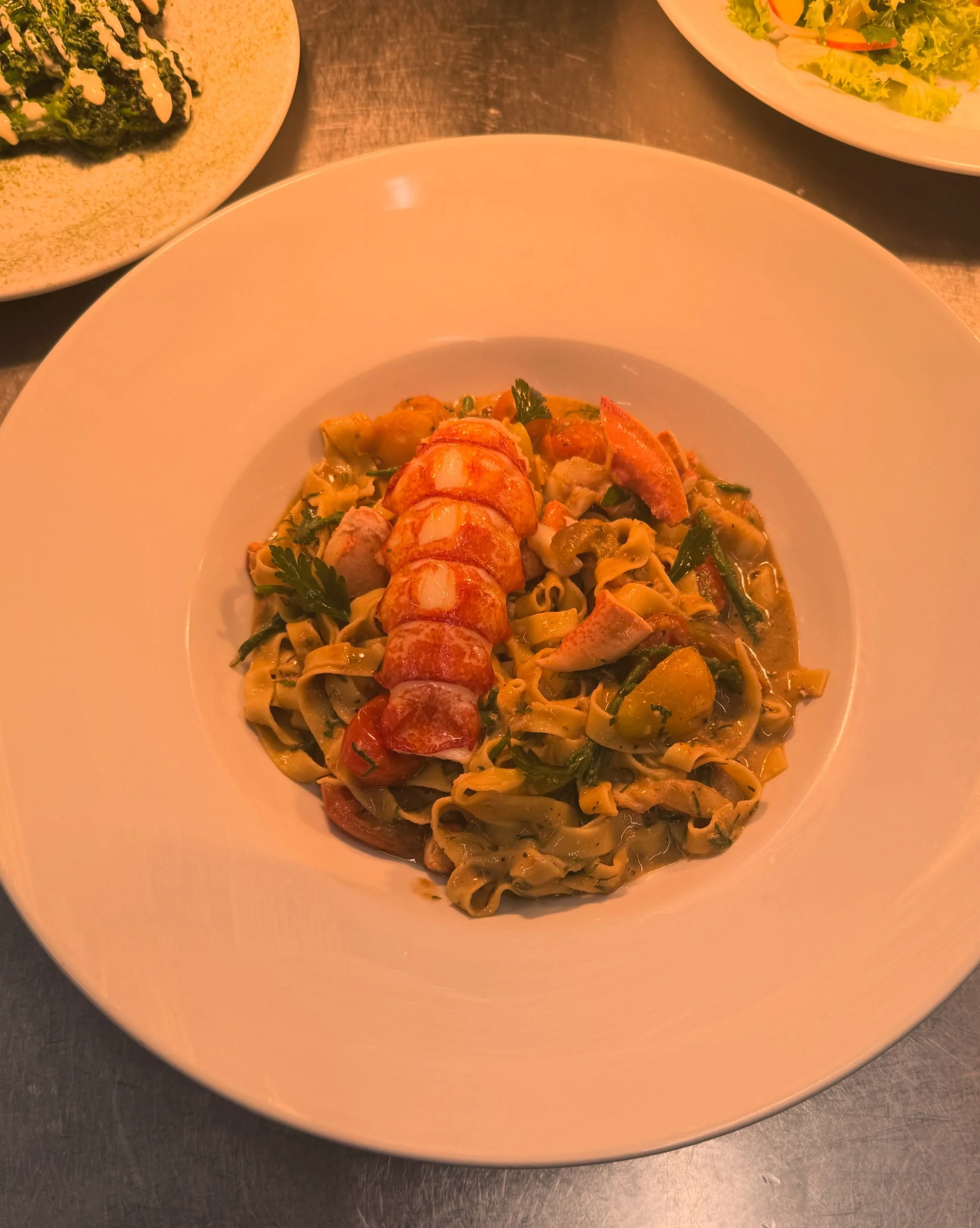 Fresh lobster, homemade fettuccine, soul farm tomatoes - our new lobster fettuccine dish on the Special Board now! 🦞