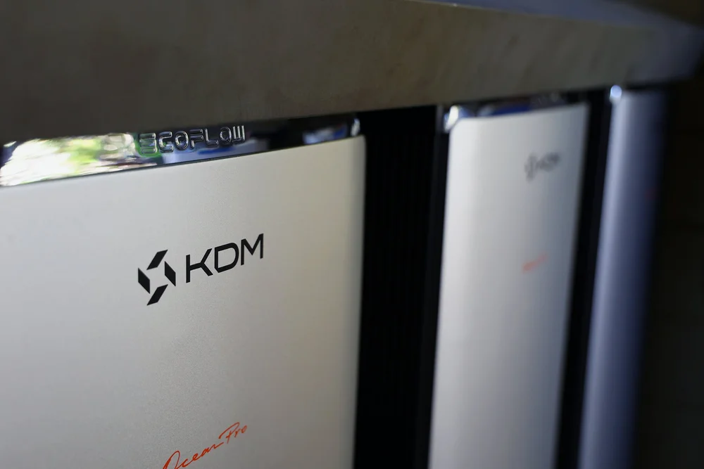 Three of the eight EcoFlow batteries, branded KDM Energy, installed in the north-facing enclosure at Court & Current Estate