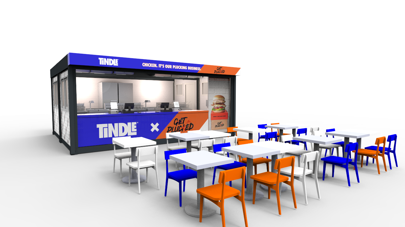 An outdoor seating area near a food stand with colorful chairs and tables. The stand has signage with the brand name TINDLE and an advertisement for chicken sandwiches.