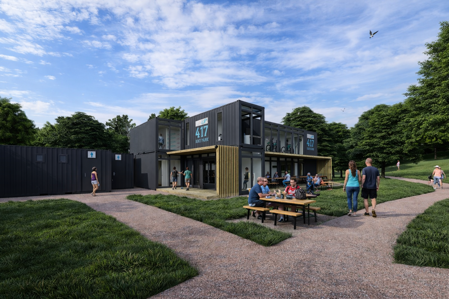 People walking, sitting at outdoor tables, and cycling near a modern two-story black container building with signs that read '417 TREELINE PARK' in a park setting with trees, grass, and pathways under a blue sky with clouds.