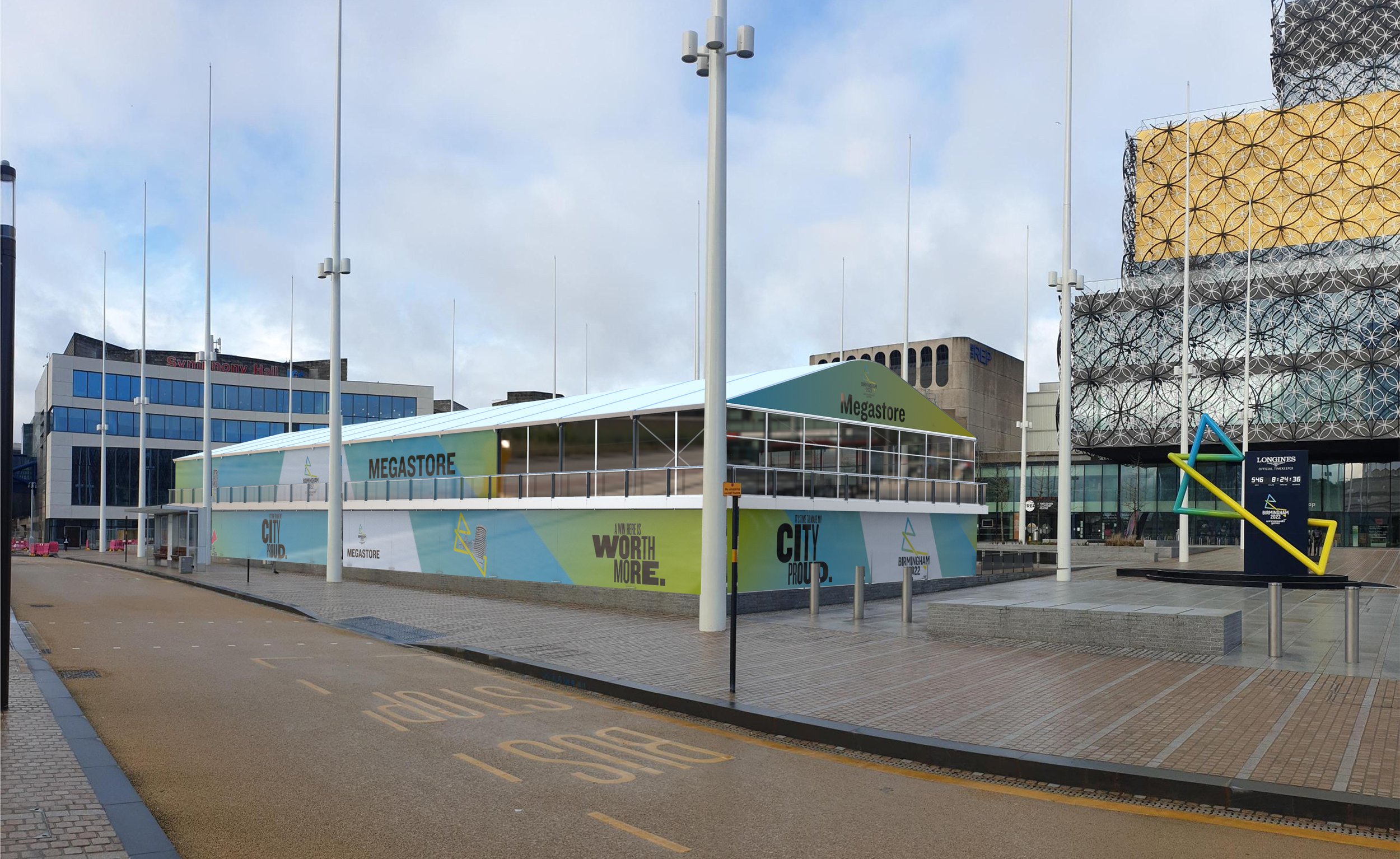 Empty urban area with a modern building labeled 'MEGASTORE,' large advertisement on the side reading 'WORTH MORE,' and decorative yellow and green structures, with a cloudy sky overhead.