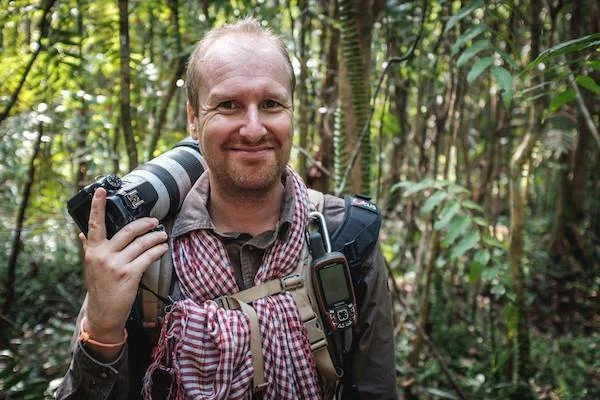 Stephane De Greef wielding his camera in a Cambodian forest