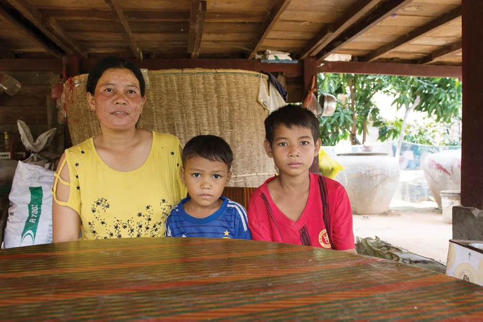 Lao Roun, a villager in Chan Leas Dai, sits with her sister's sons