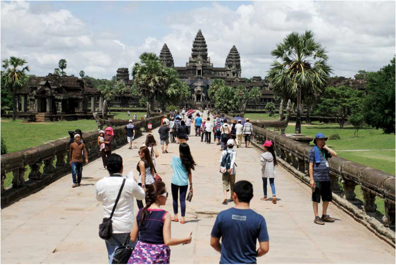 Tourists walk along a causeway leading to Angkor Wat, the crown jewel of the Angkor Temple Complex near Siem Reap, Cambodia