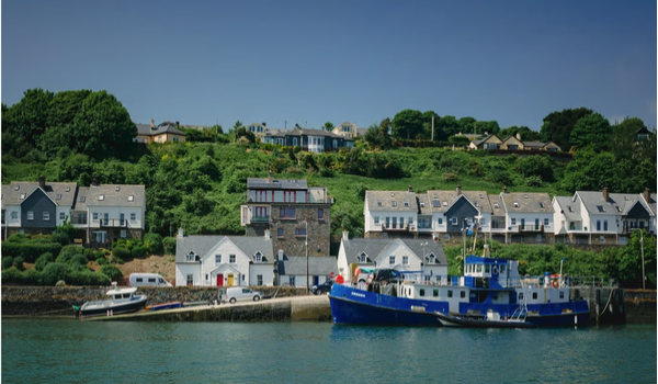 Fishing boats moored along a pier in Kinsale, Ireland