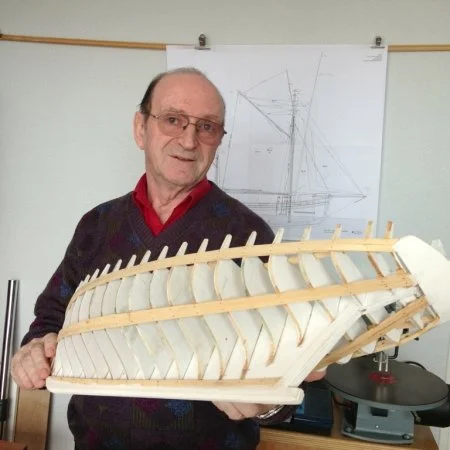 Jean Claude Rosso, part of the team behind the reconstruction of La Biche, holding up a scale model he built himself