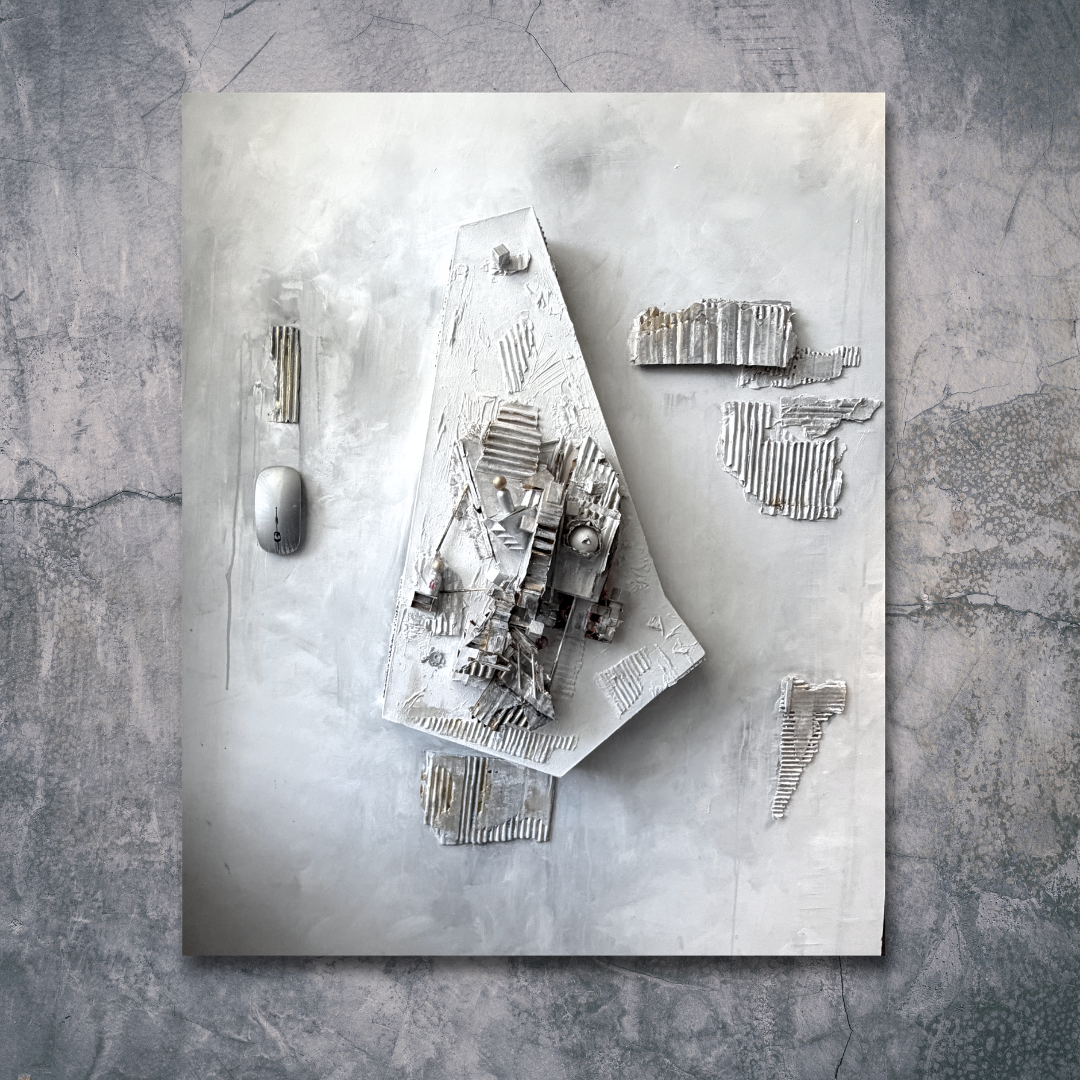 A 3D architectural model displayed on a white board, surrounded by broken pieces of similar material, with a computer mouse and a stylus on the side, set against a textured concrete floor.