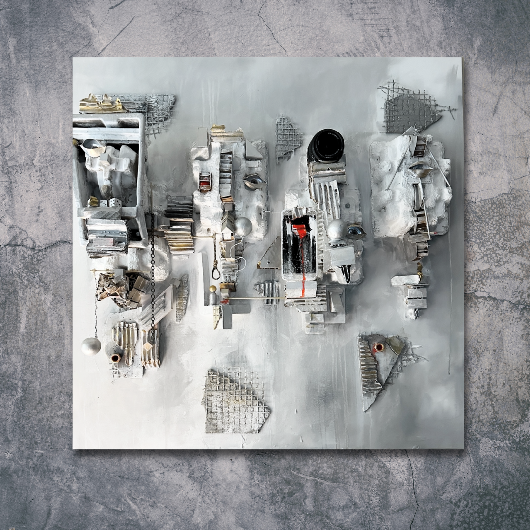 An abstract mixed-media sculpture with a predominantly gray and white color scheme, featuring various textured and layered elements like metal, wood, and fabric, mounted on a square panel. The sculpture includes geometric shapes, chains, and small objects arranged in an intricate composition.