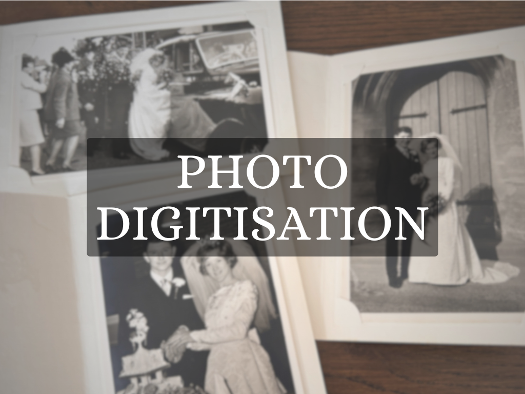 A photo of a wedding album and old photographs for photo digitisation.