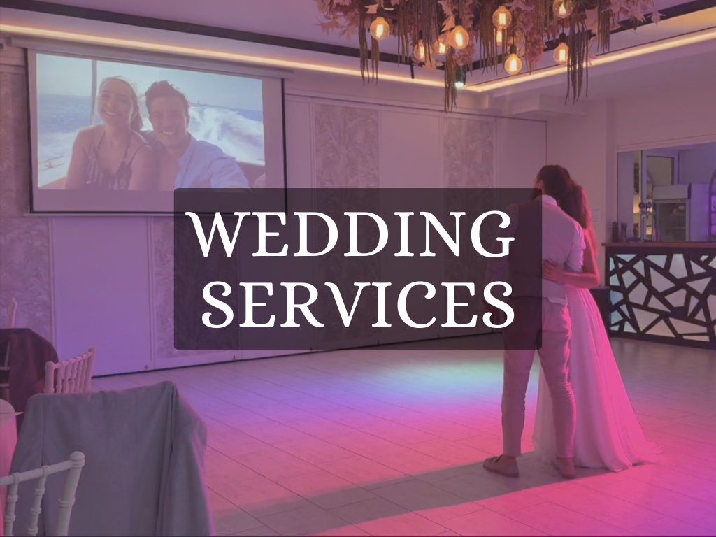 A photo of a couple on their wedding day looking at their 'Story of Life' video.