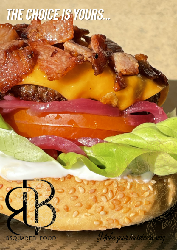 Close-up of a burger with crispy bacon, melted cheddar cheese, tomato, pickled onions, lettuce, and mayonnaise on a sesame seed bun with text "The choice is yours..." and the BSquared Food logo.