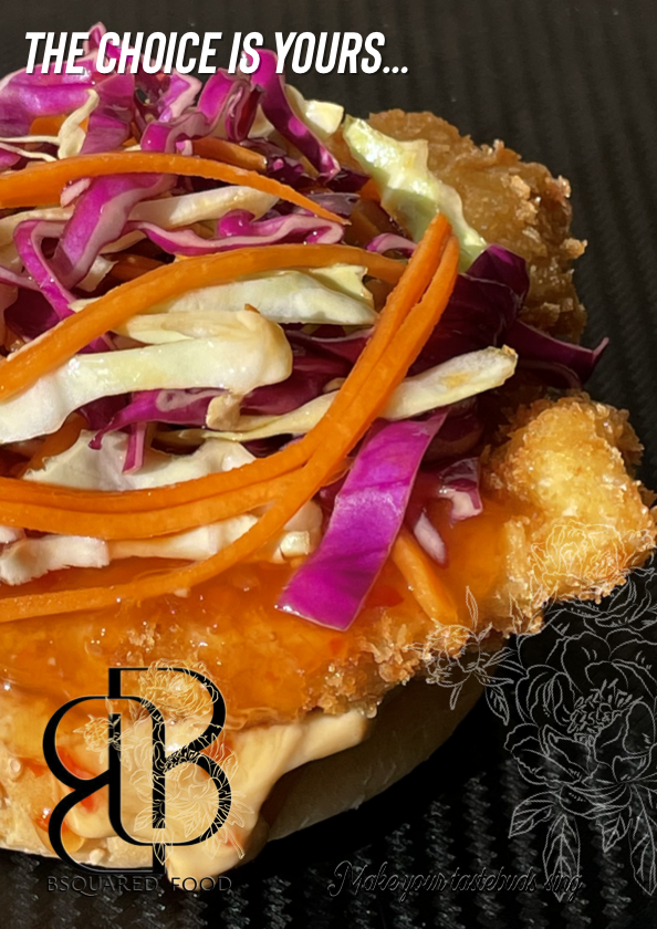 A crumbed chicken breast topped with shredded coleslaw and carrots, garnished with asian coleslaw, with the text "The choice is yours..." in the top left corner.