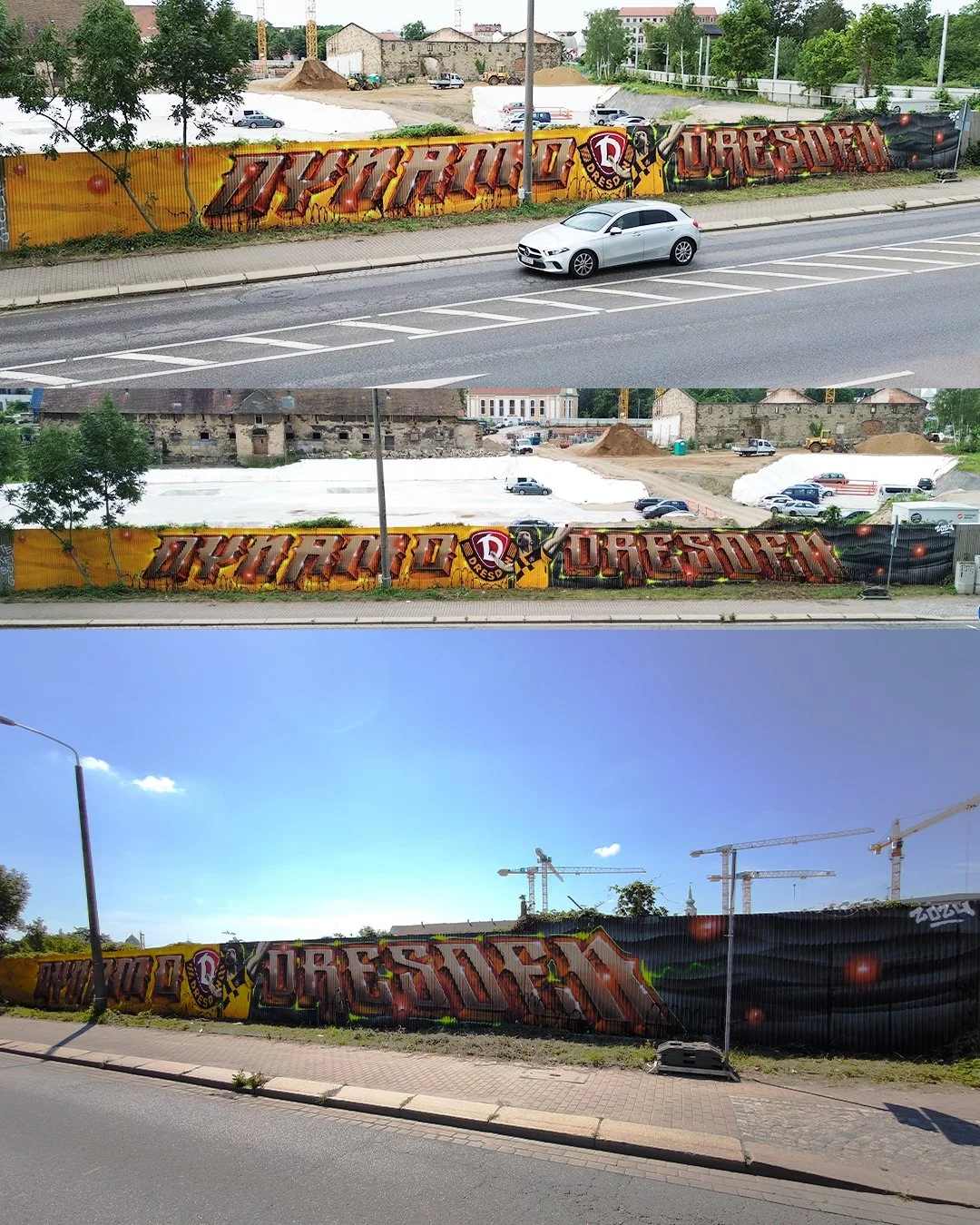 Graffiti auf einer hohen Metallzelte vor einer Baustelle, mit dem Text 'Dresden' und einem Energiedrink-Logo, bei sonnigem Wetter.