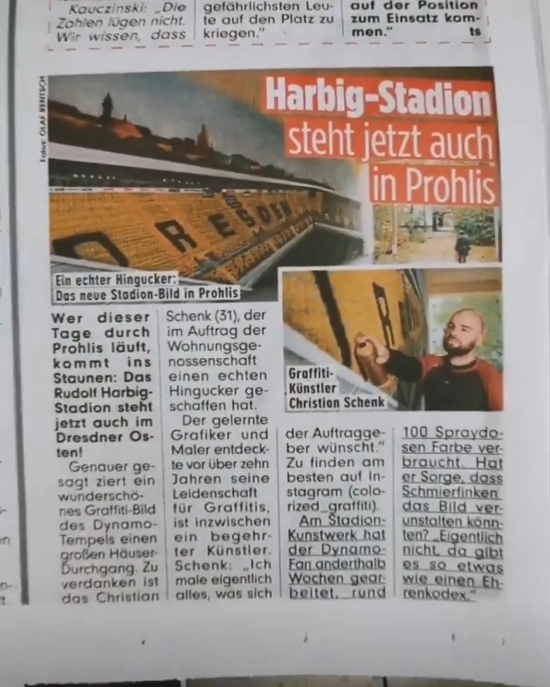 Zeitungsartikel über die Eröffnung des Harbig-Stadions in Prohlis, mit einem Bild des Stadions, einem Graffiti-Künstler Christian Schenk, der eine Wand bemalt, und Textinformationen.
