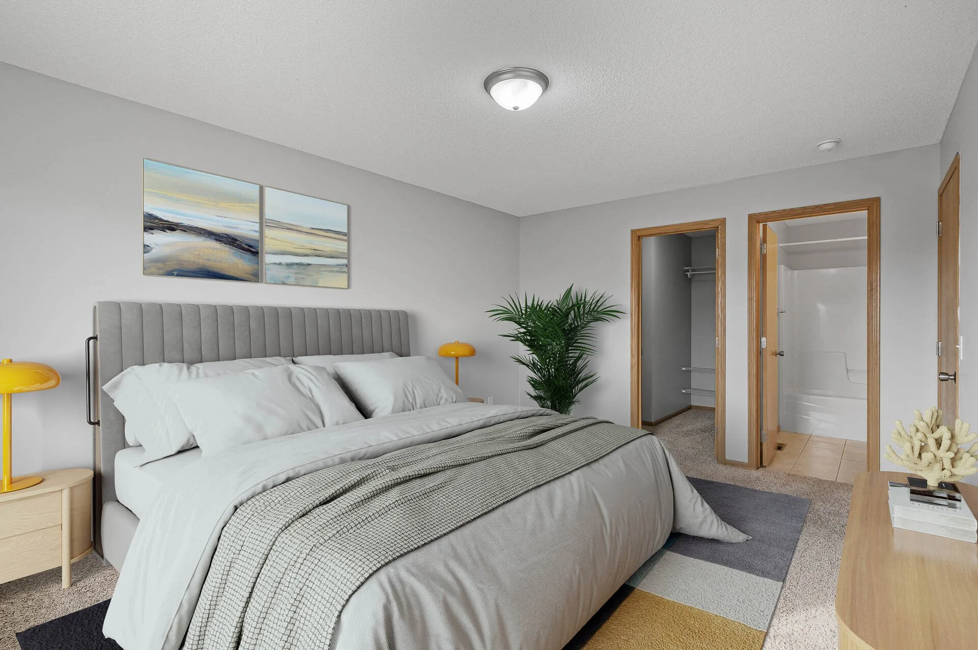 A bedroom with a large bed dressed in white and gray linens, two yellow bedside lamps, a green potted plant, and two open closets with shelves, all in a modern style with light gray walls and wooden accents.