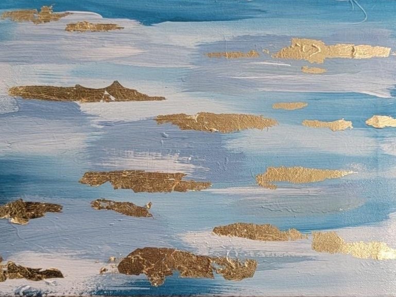 Abstract painting with blue and white background, featuring gold foil accents resembling clouds or islands.