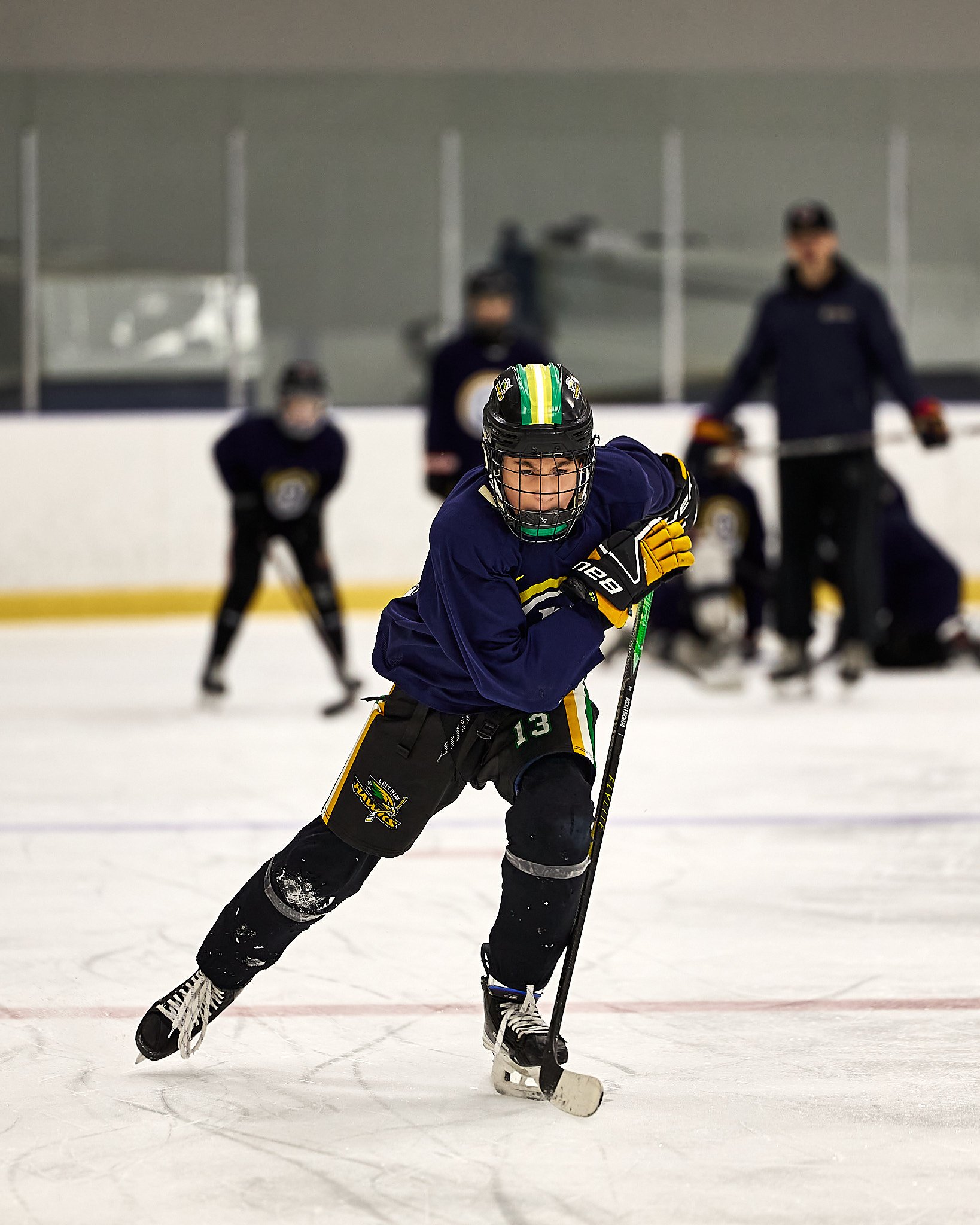 young hockey player skating in a rink