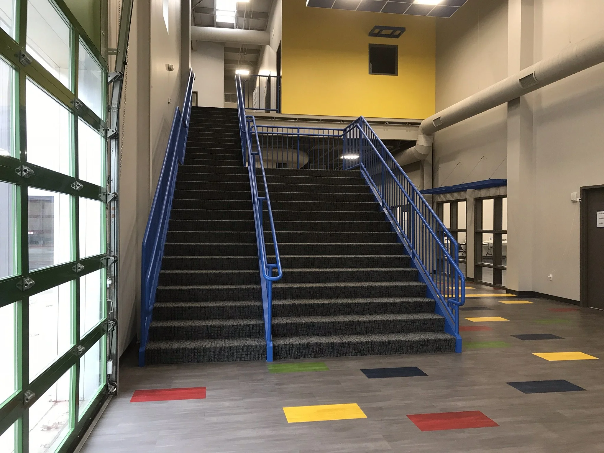 Powder-Coated Steel Stair and Handrail System Fabricated for Interior Circulation at the Ethos Innovation Center.