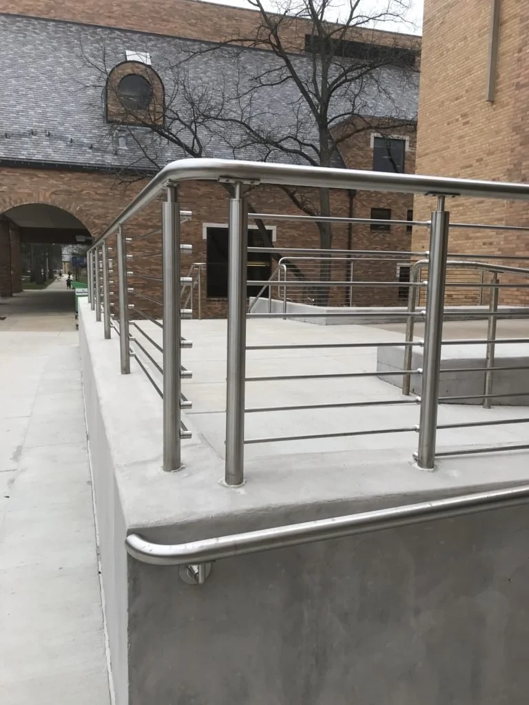 Stainless Steel Guardrails Fabricated and Integrated with Exterior Concrete Ramp Systems.