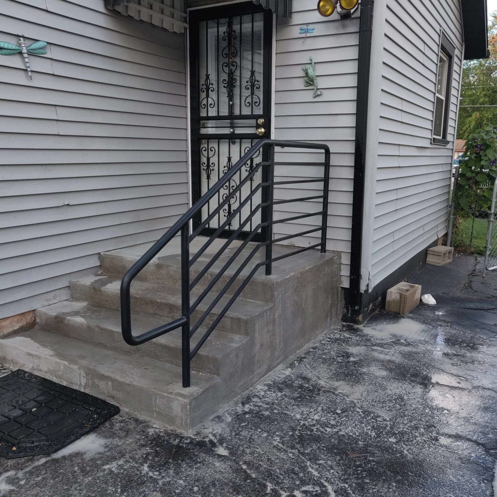 Custom Powder Coated Entry Handrail Providing Safe Access to the Home's front Entrance.