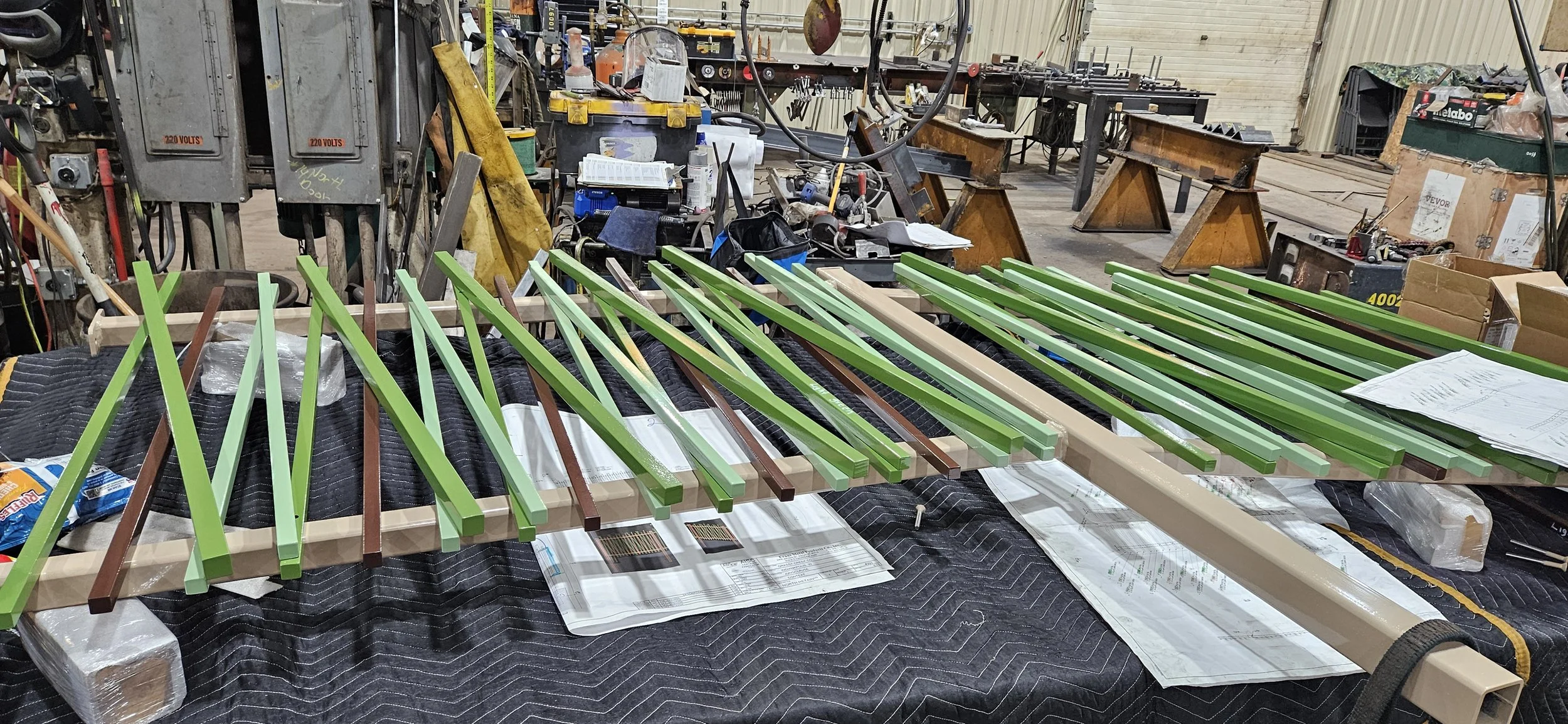 Painted steel components staged for quality control and project shipment.