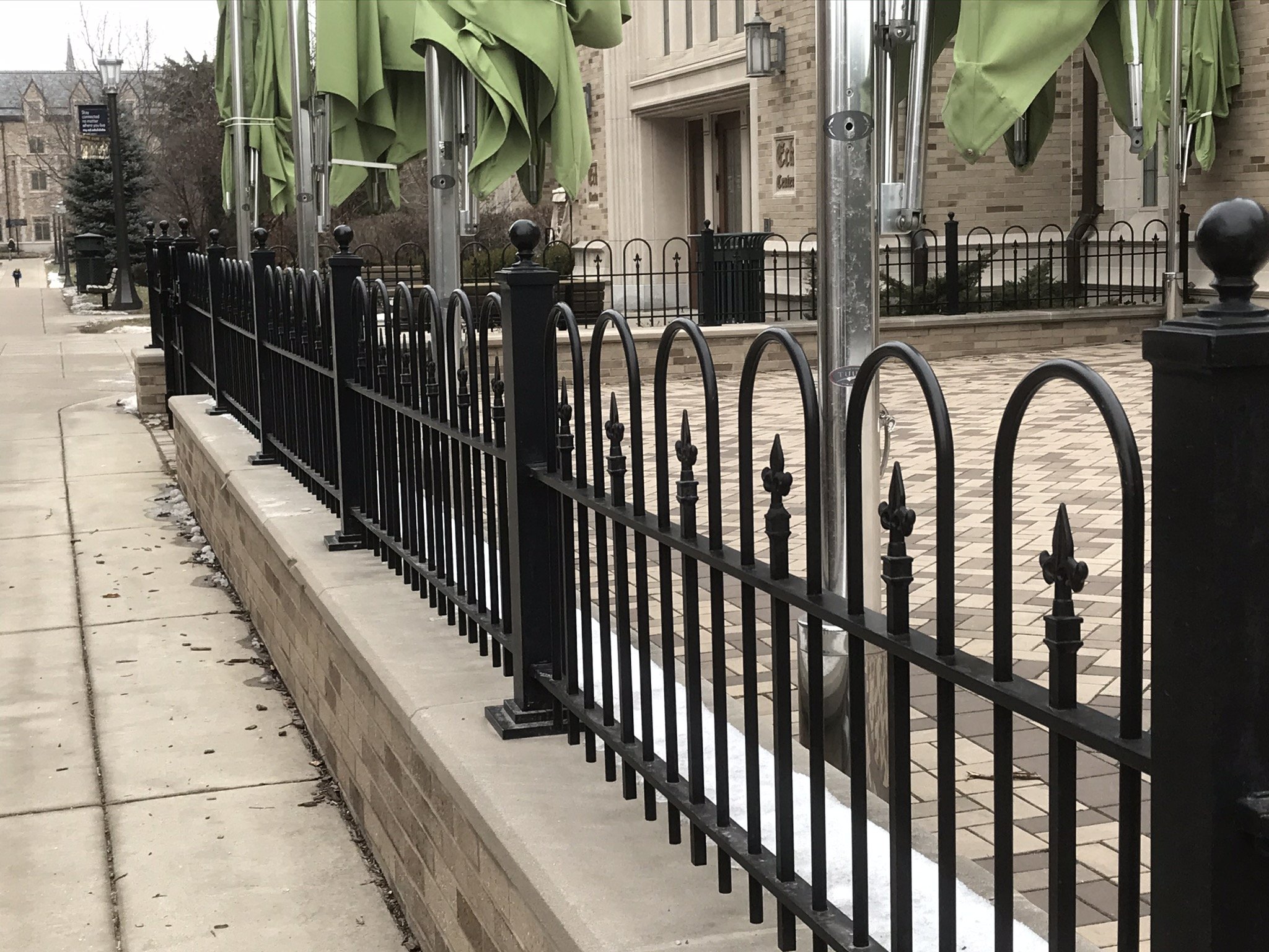 Custom Ornamental Steel Fence System Installed Along Outdoor Gathering Areas at the Eck Visitors Center, University of Notre Dame.