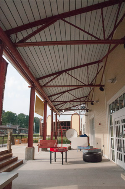 Steel Canopy Framing Supporting a Covered Outdoor Activity Area, Designed to Integrate Structure, Durability, and Open Circulation.