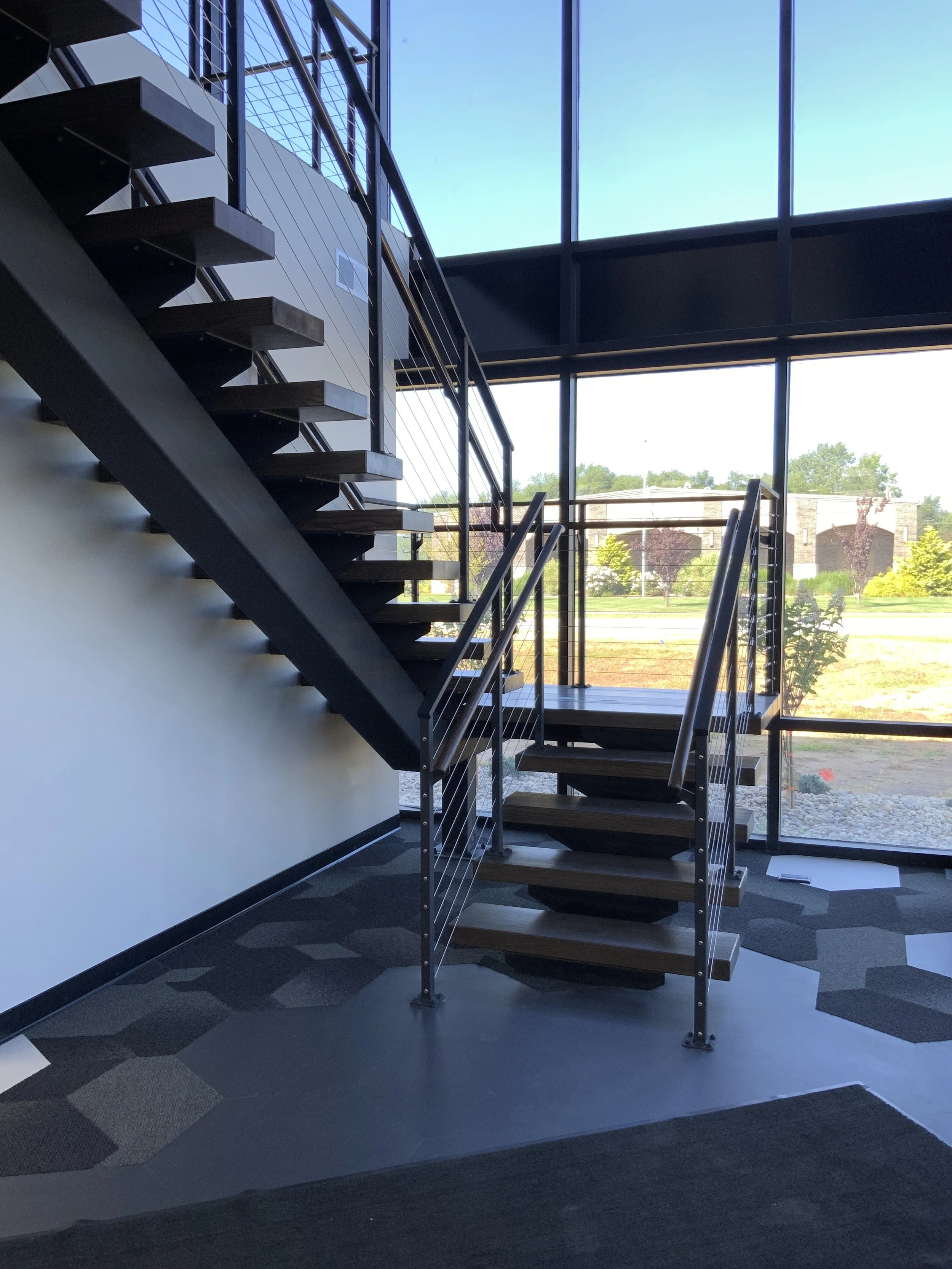 Modern interior stair with custom metal railing.