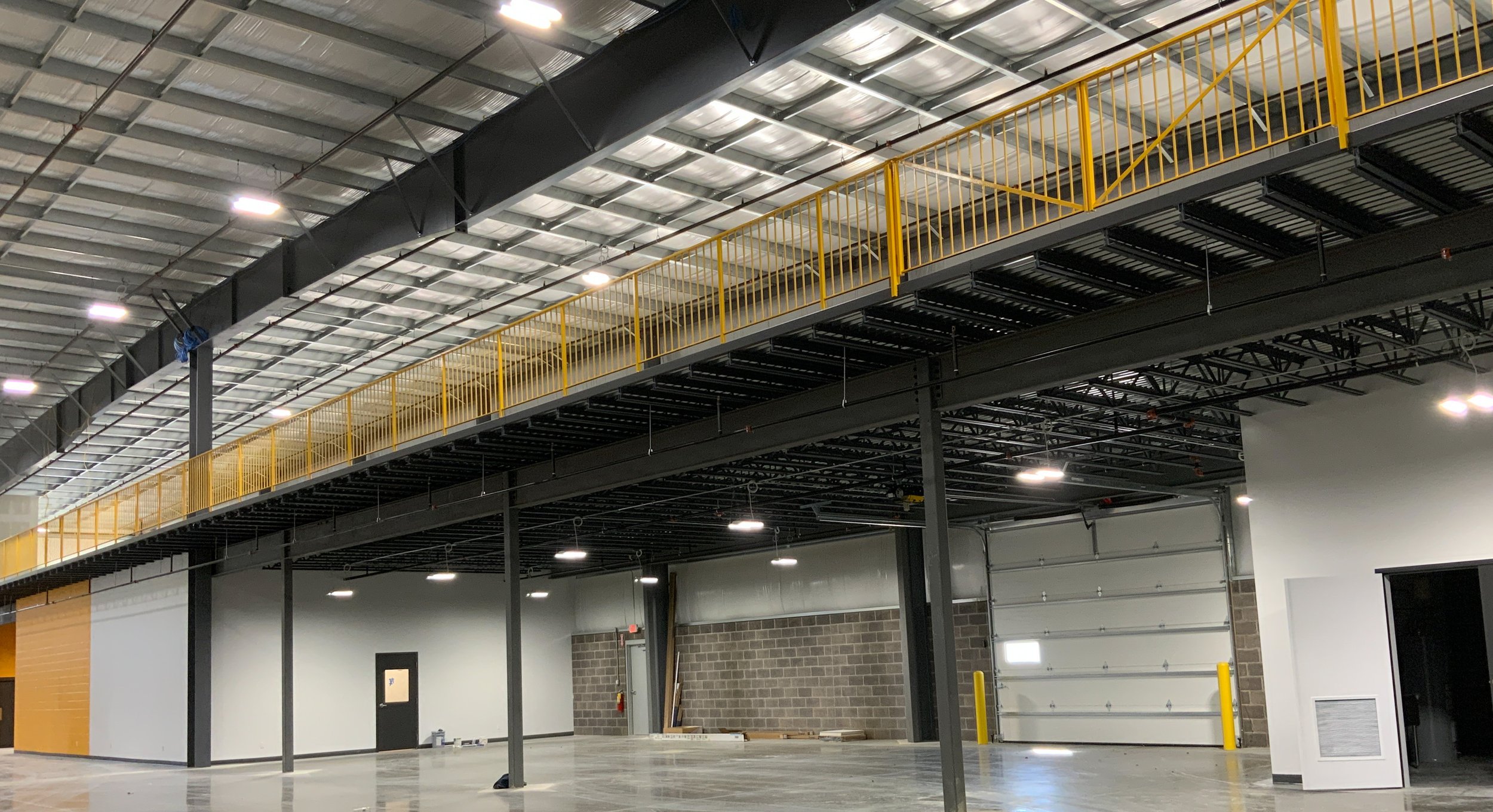 Interior steel guardrail system fabricated for elevated warehouse platform.