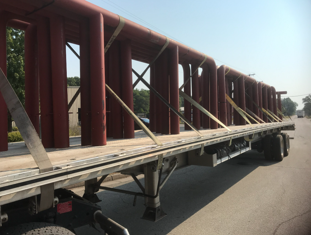 Fabricated steel bollards loaded for delivery to job site.