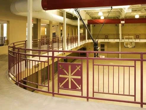 Curved Interior Railing System Fabricated for Upper-Level Circulation Within the Campus Building.