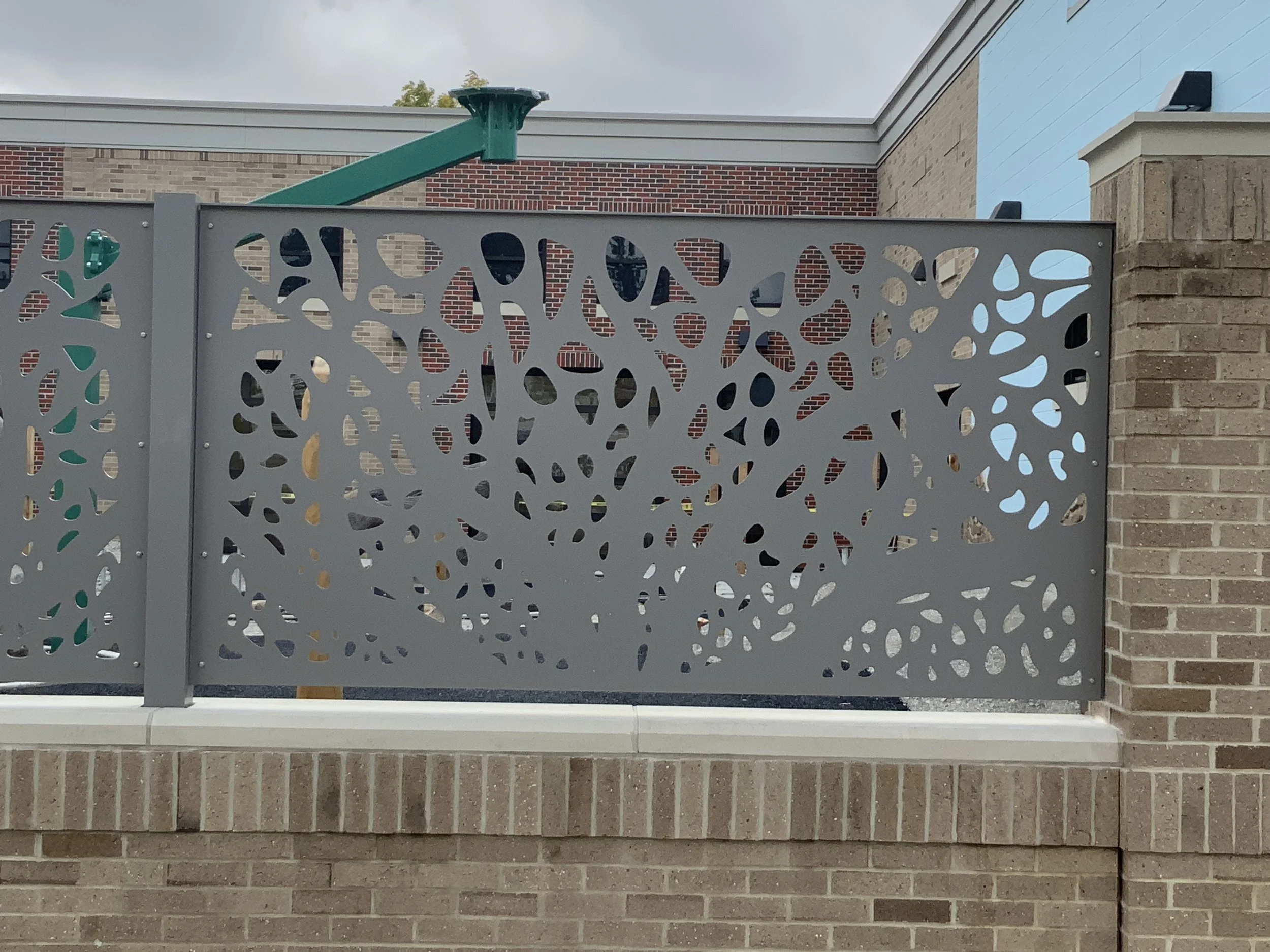 Custom Laser-Cut Metal Screen Panels Fabricated for Playground Enclosure.