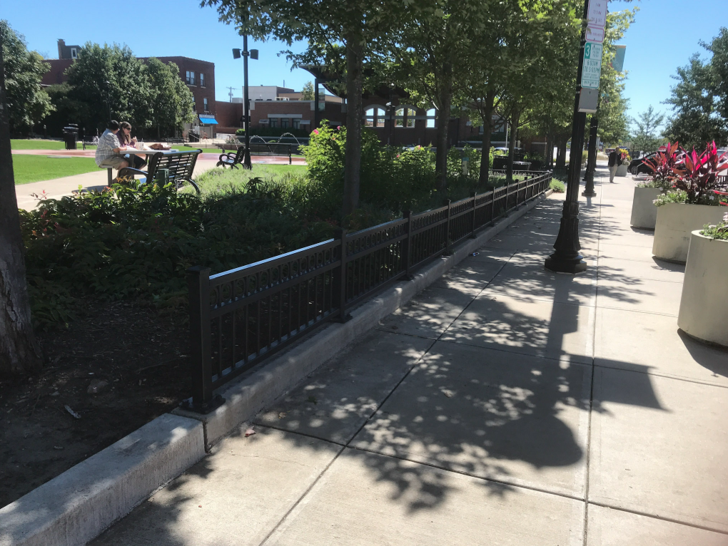 Custom railing sections coordinated with site grading and hardscape features to integrate seamlessly into the park environment.