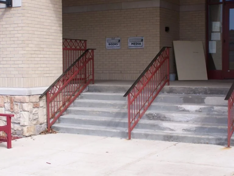 Decorative Steel Stair Railings with Cross-Pattern Infill Fabricated for Public Access at the Olive Township Library.