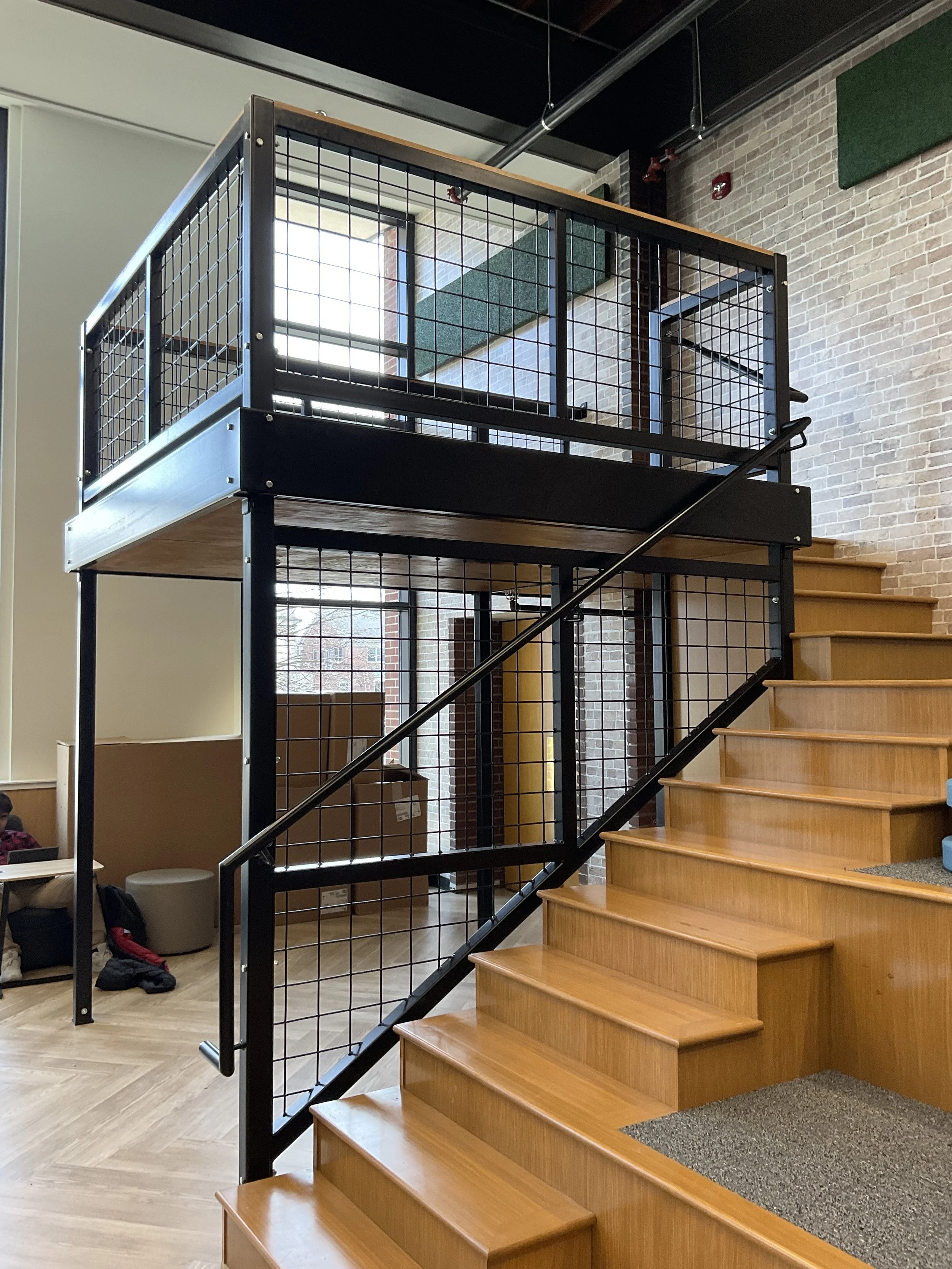 Interior stair with custom metal railing and wood treads.