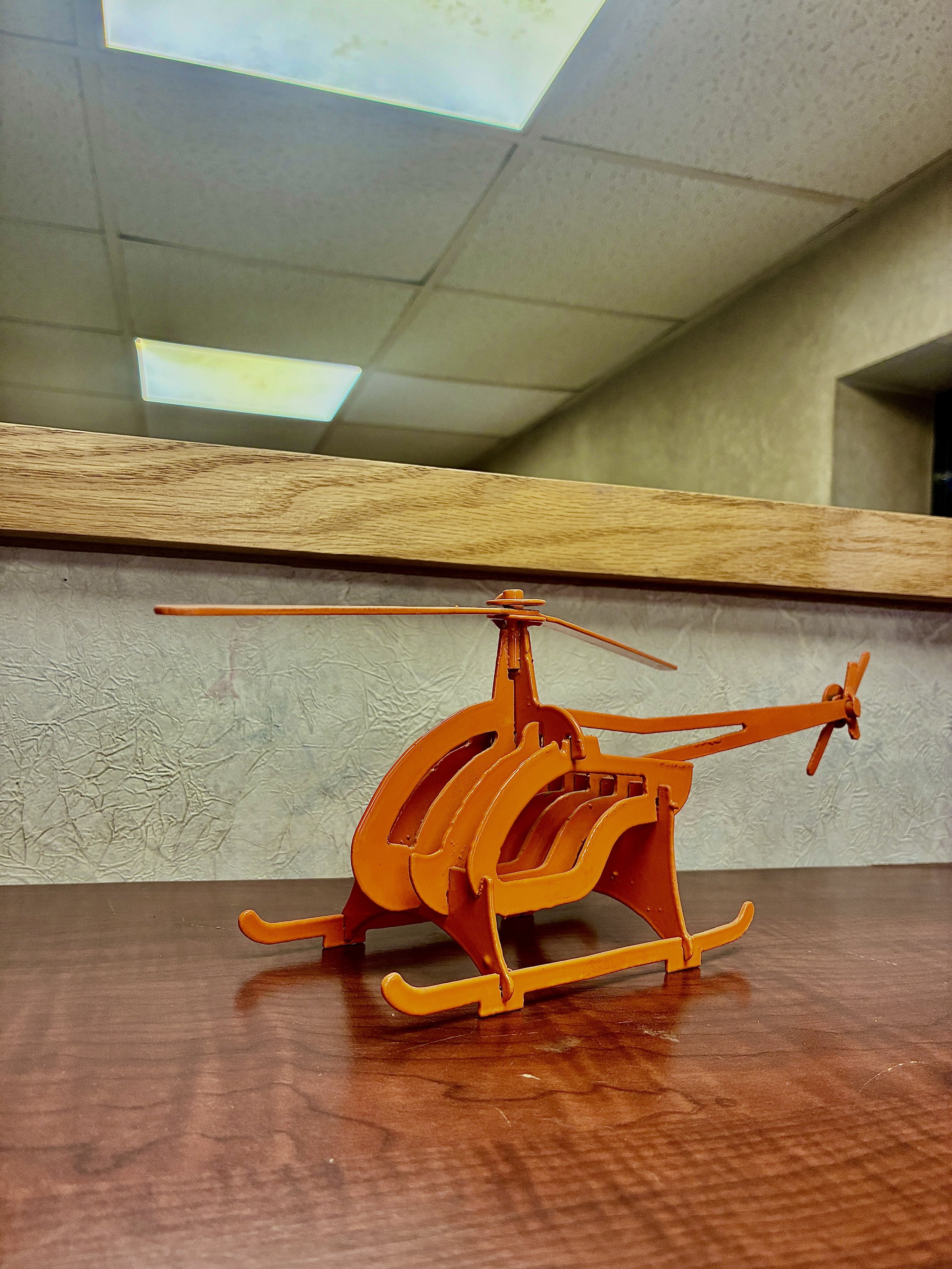 Custom Fabricated helicopter displayed on table.