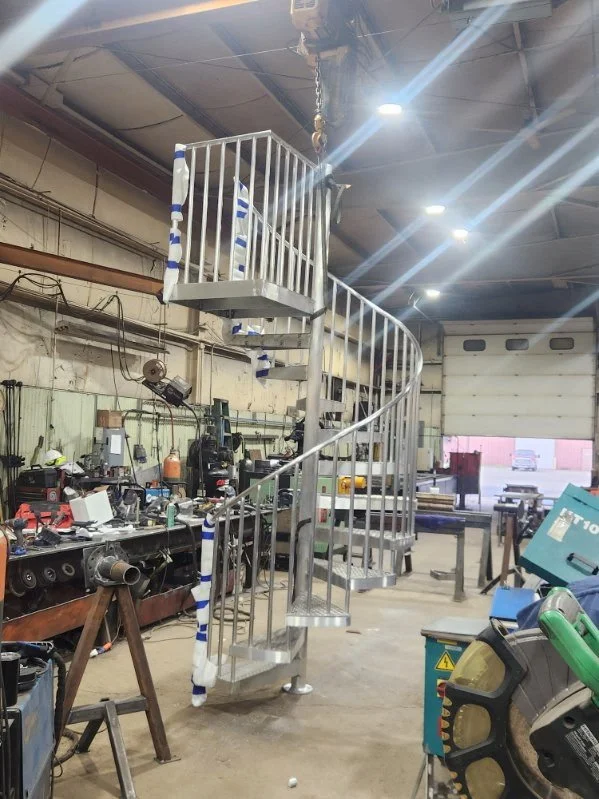 Completed custom steel spiral staircase fabricated and assembled in the shop.