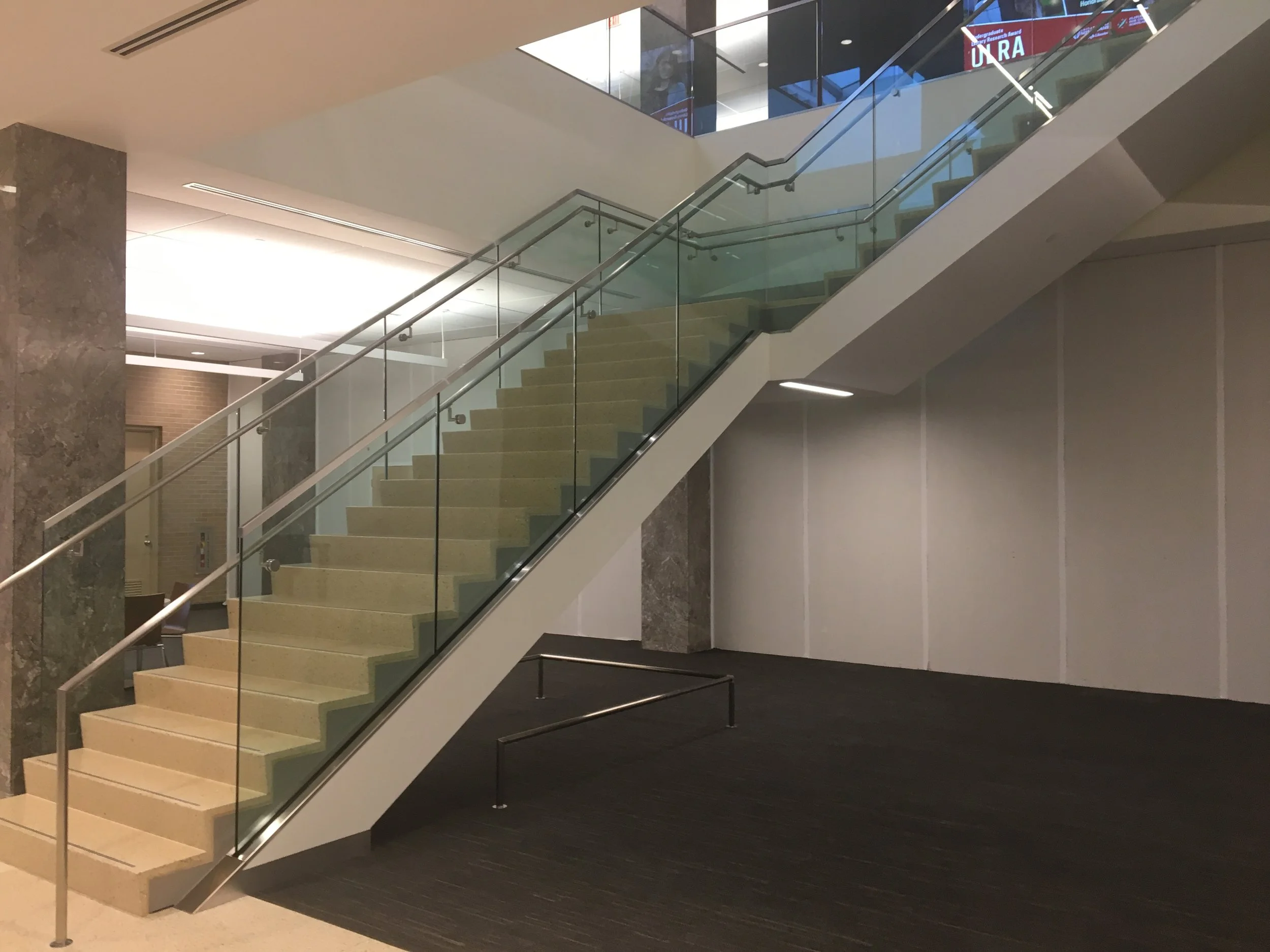 Custom Glass Guardrail and Stainless Steel Handrail System Installed as Part of the Hesburgh Library Renovation.