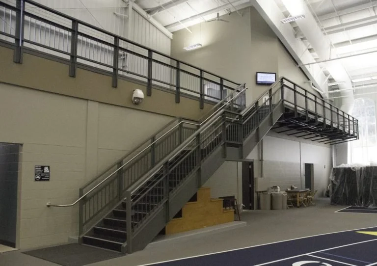 Custom Fabricated Steel Stair and Guardrail System Serving Interior Mezzanine and Upper-Level Access at Hillsdale College.