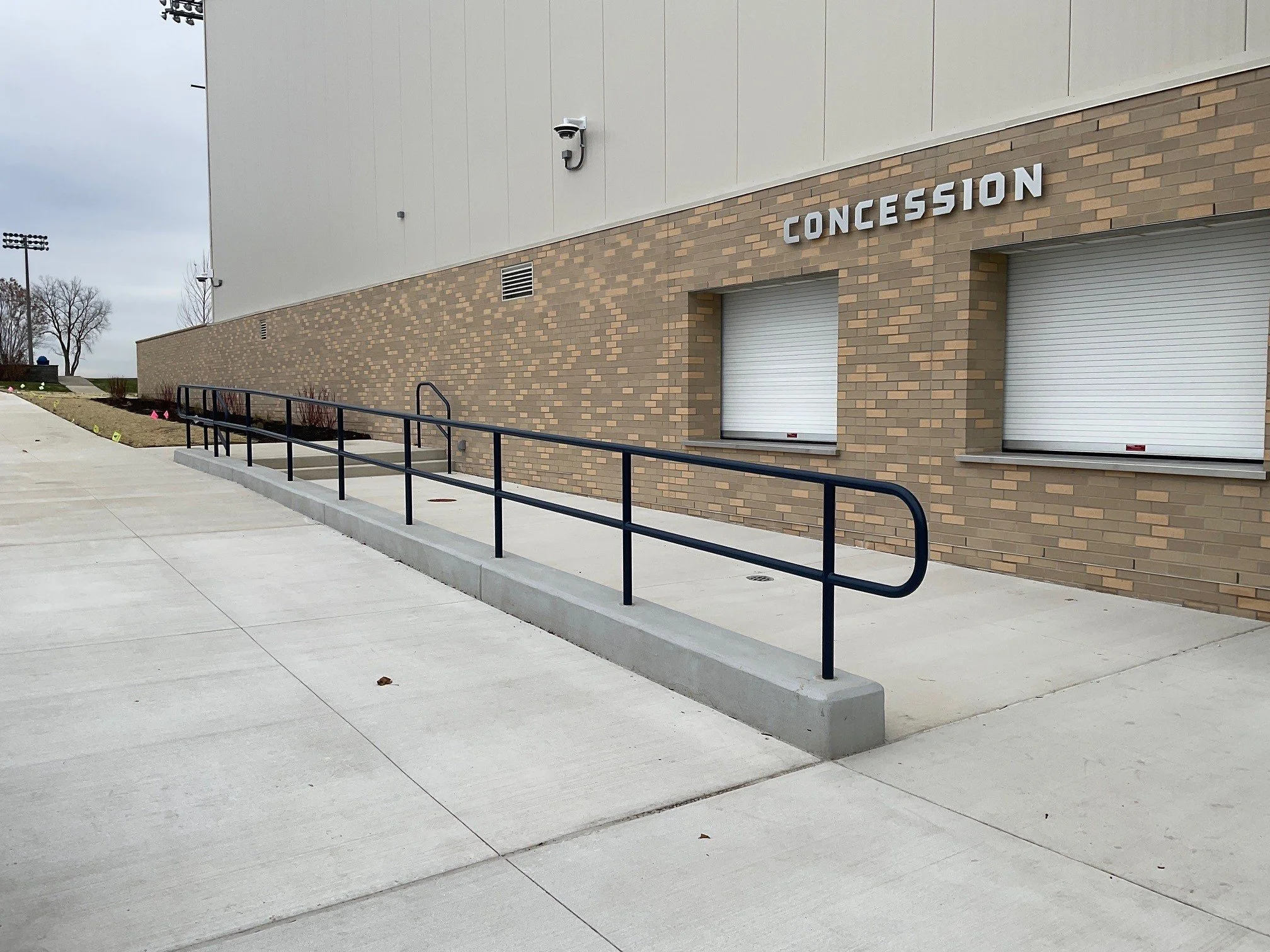 ADA-Compliant Exterior Steel Handrail System Installed Along Athletic Facility Concession Areas.